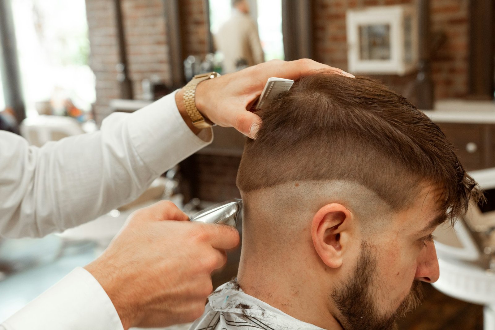 Barber cutting a clean fade with clippers